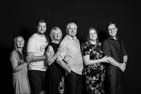 black and white studio portrait of family by Darryl Brooks Photography