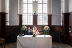 wedding couple signing register inside Champney treasure house in Beverley