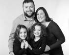 black adn white photo of family, with 2 girls