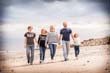Family walking on the beach in the sun