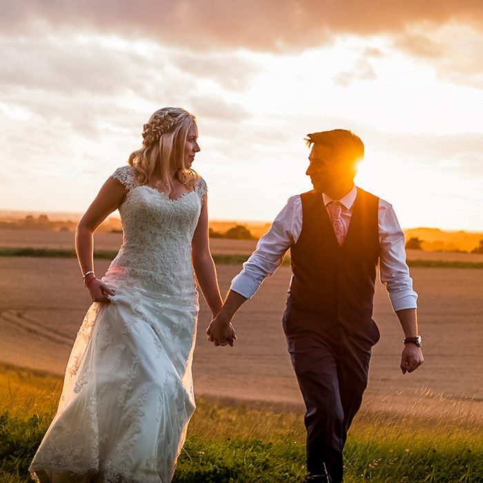 romantic wedding couple holding hands at sunset  East Yorkshire